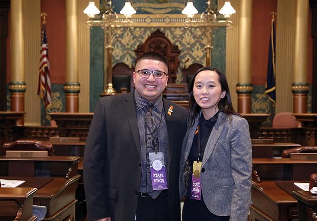 State Rep. Stephanie Chang (D-Detroit) attends the 2018 State of the State address at the Michigan State Capitol on Tuesday, Jan. 23, 2018, with guest Alex Garza, president of the Taylor City Council.