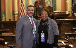 State Rep. Tyrone Carter (D-Detroit) joined by Western Wayne County NAACP President Gina Wilson-Steward for Gov. Whitmer's first State of the State address in the Capitol in Lansing on Tuesday, Feb. 12, 2019