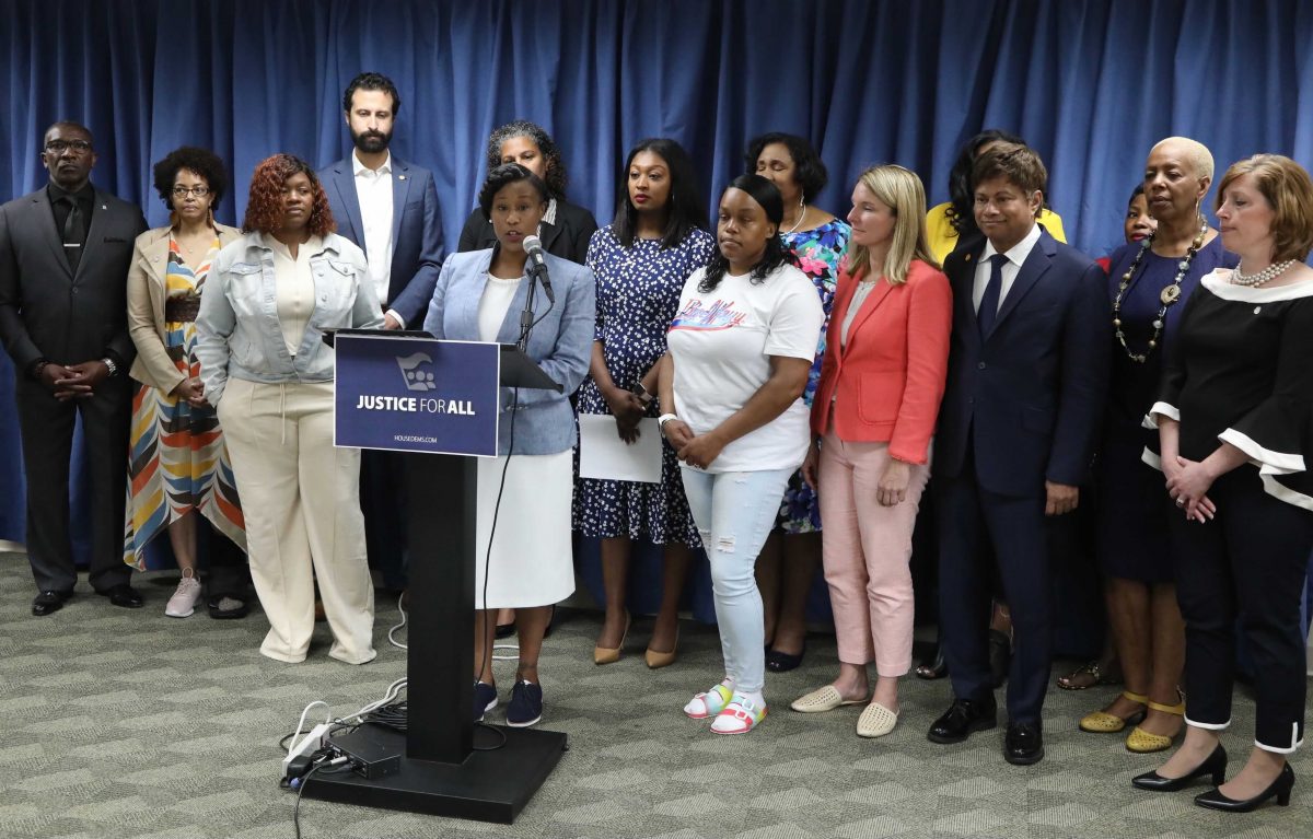 State Rep. Julie Rogers (D-Kalamazoo), far right, listens with fellow legislators and members of Breonna Taylor’s family as state Rep. Tenisha Yancey (D-Detroit), chair of the Detroit Caucus, speaks during the Justice For All press conference on Tuesday, June 8, in Lansing.