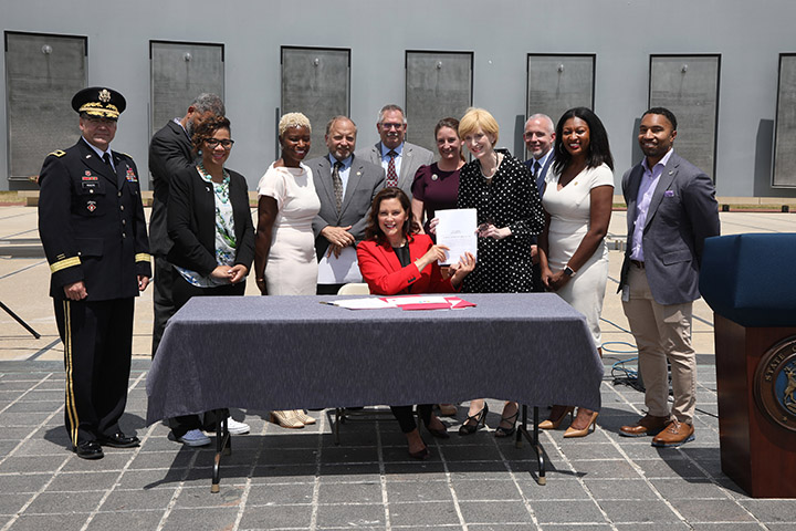 State Rep. Sarah Anthony (D-Lansing) joined Gov. Whitmer and other stakeholders for the signing of a package of bills that will remove barriers to help veterans and their families continue their careers in Michigan, on June 9, 2021.