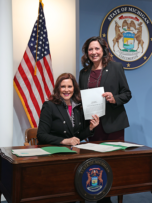 State Rep. Angela Witwer (D-Delta Township) joined Governor Whitmer for the signing of House Bills 4562 and 4563, on March 11, 2022. The bills give parole boards the option to conduct the subsequent review of prisoners every five years, instead of annually, after a denial of parole if the majority of the parole board finds that the prisoner’s history indicates there is a present risk to public safety.