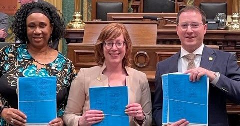 From left to right, Reps. Stephanie Young, Julie Rogers and Graham Filler hold copies of bills they've introduced to expand support for crime victims.