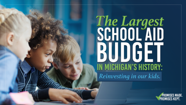 Photo of three kids looking at a laptop together. Text at right reads, "The largest school aid budget in Michigan's history. Reinvesting in our kids."