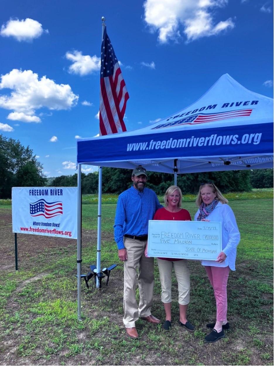 State Rep. Jennifer Conlin (D-Ann Arbor Township), right, secured $5 million for Freedom River, a 93-acre recreation site helping to reintegrate U.S. service members, veterans and their families. Jeff Yeakey, left, is a veteran, and Janna Yeakey is the executive director of Freedom River.
