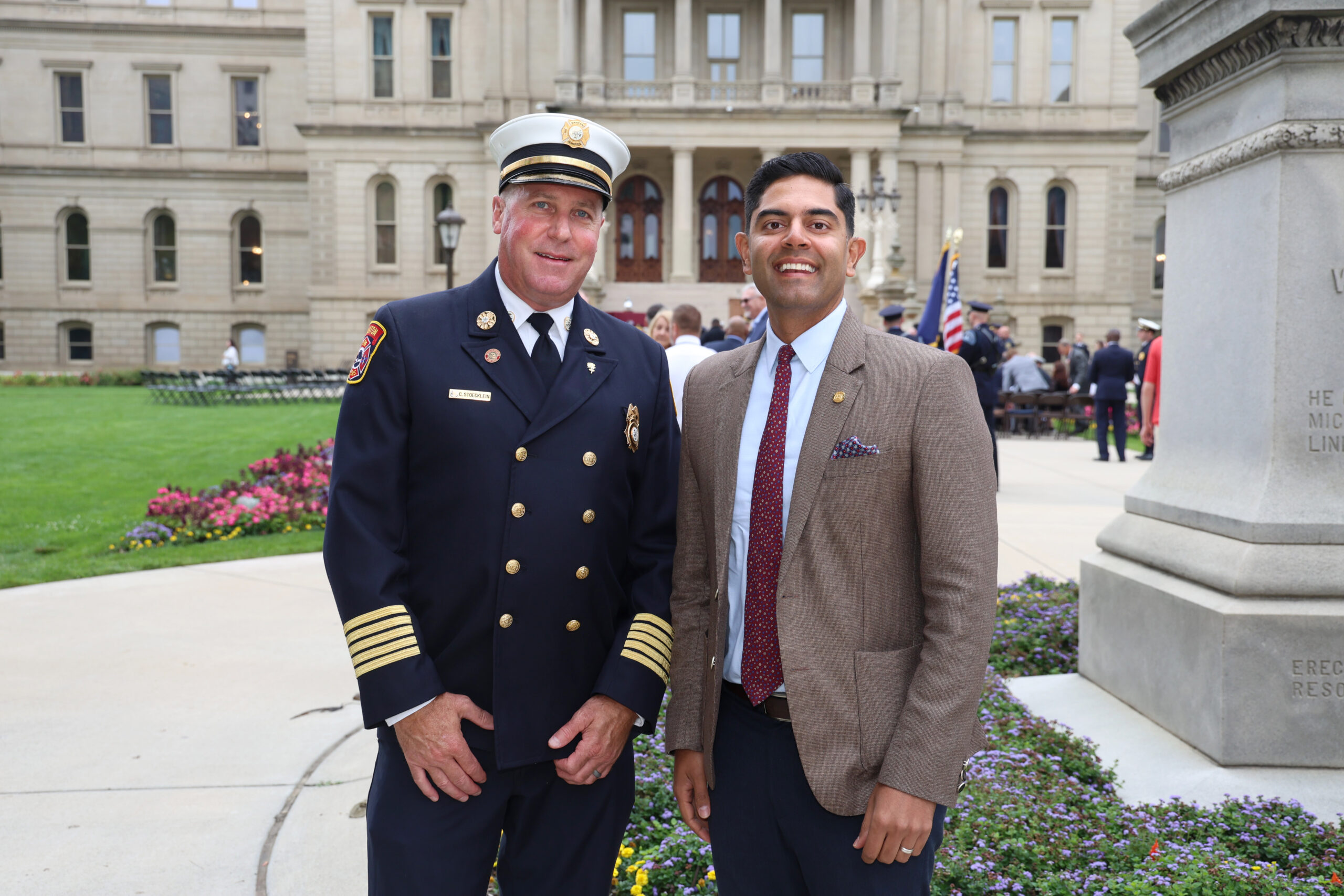 Rep. Puri stands with Canton Township Fire Chief Christopher Stoecklein on the Michigan Capitol lawn.