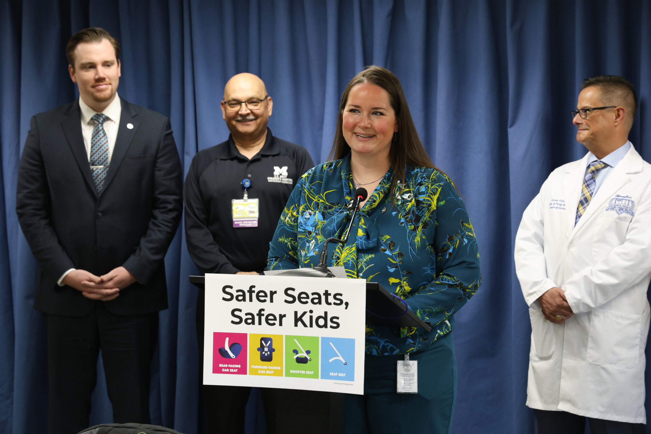 State Rep. Carrie A. Rheingans (D-Ann Arbor) stands at the podium during her and state Rep. John Fitzgerald’s (D-Wyoming) Safer Seats, Safer Kids press conference on May 4, 2023, at the House Office Building in Lansing.