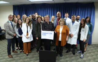 State Reps. Carrie Rheingans (D-Ann Arbor), Donavan McKinney (D-Detroit), Reggie Miller (D-Van Buren Township) and Curt VanderWall (R-Ludington), along with health care workers and students, stand together after the Patient-Led Care press conference at the House Office Building on Oct. 5, 2023.