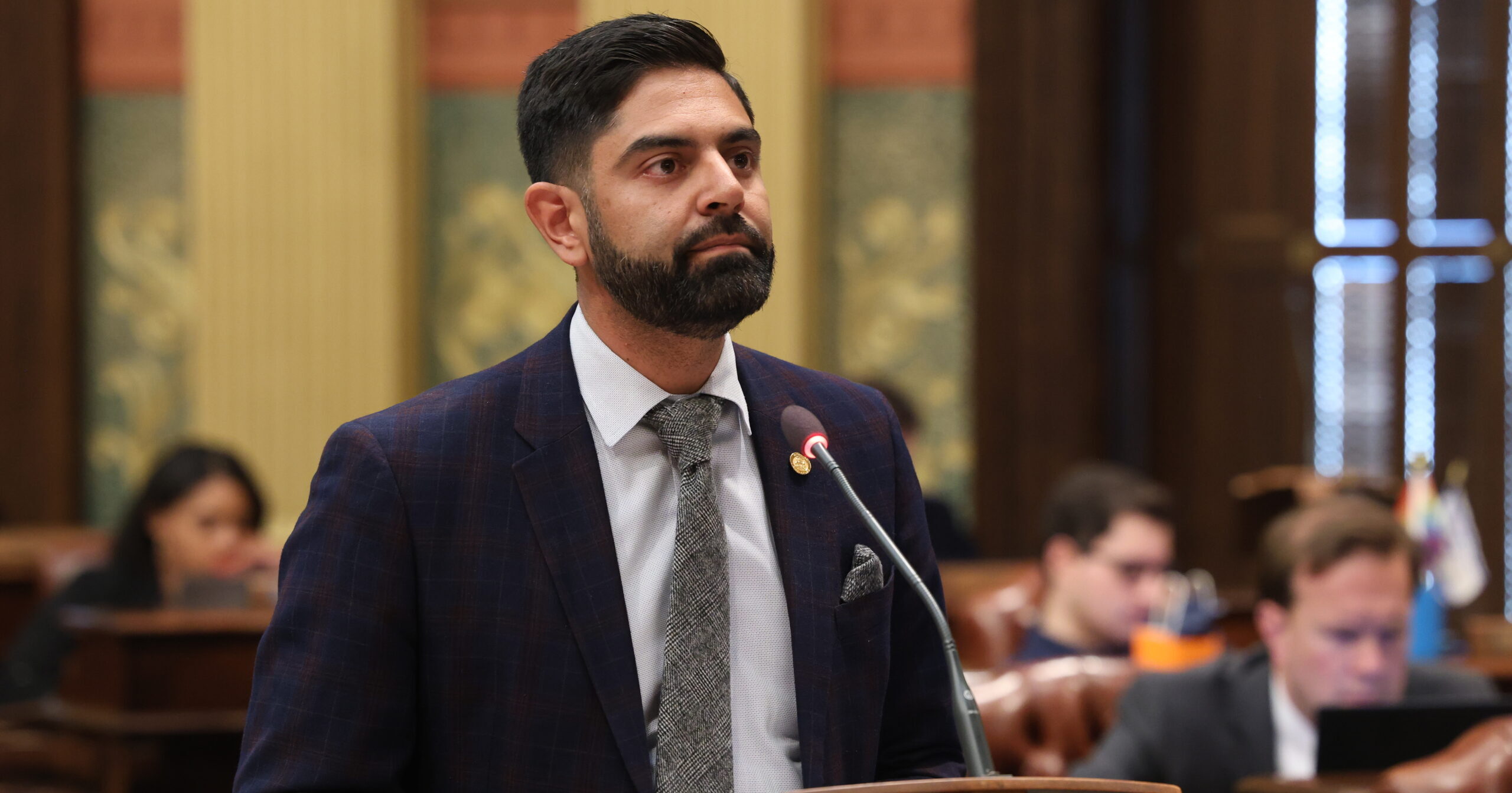 Michigan state Representative stands on the house floor ready to speak