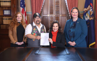 From left, Emily Paski, Gov. Whitmer’s tribal liaison; Roger LaBine, elder and rice keeper in the Lac Vieux Desert Band of Lake Superior Chippewa; Gov. Gretchen Whitmer and state Rep. Carrie Rheingans (D-Ann Arbor) pictured after the signing of House Bill 4852 at the Capitol in Lansing on Dec. 5, 2023.