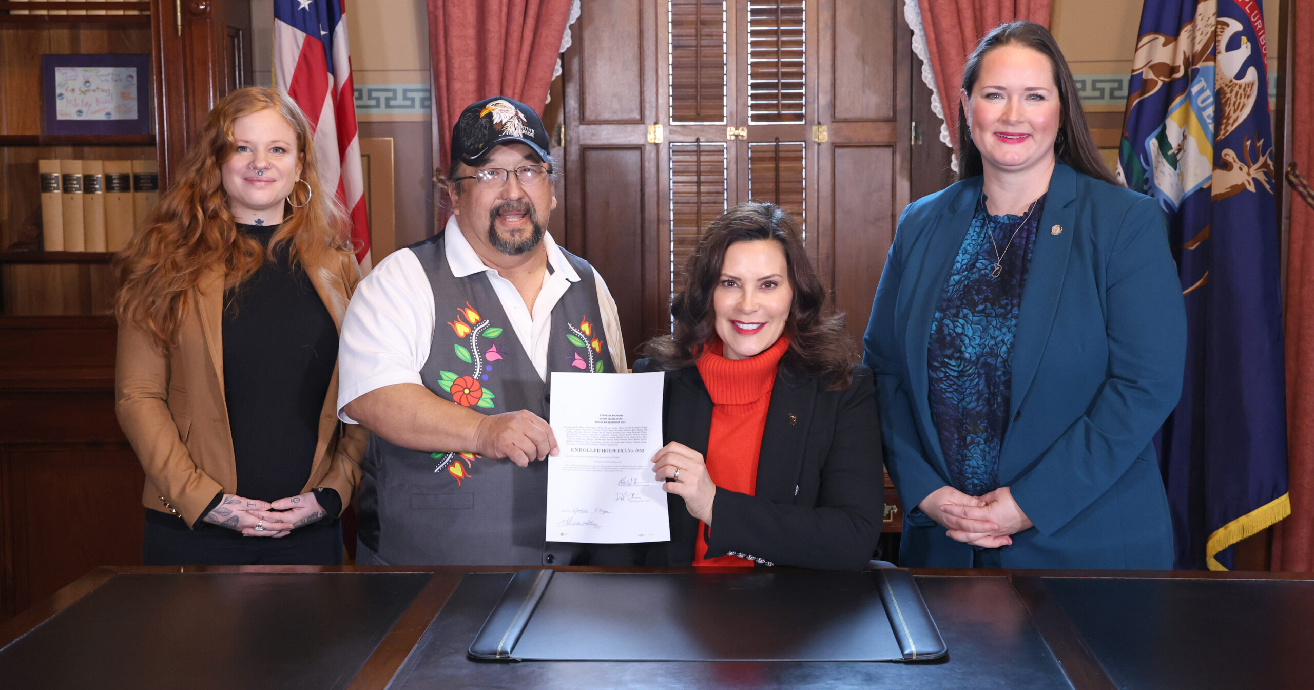 From left, Emily Paski, Gov. Whitmer’s tribal liaison; Roger LaBine, elder and rice keeper in the Lac Vieux Desert Band of Lake Superior Chippewa; Gov. Gretchen Whitmer and state Rep. Carrie Rheingans (D-Ann Arbor) pictured after the signing of House Bill 4852 at the Capitol in Lansing on Dec. 5, 2023.