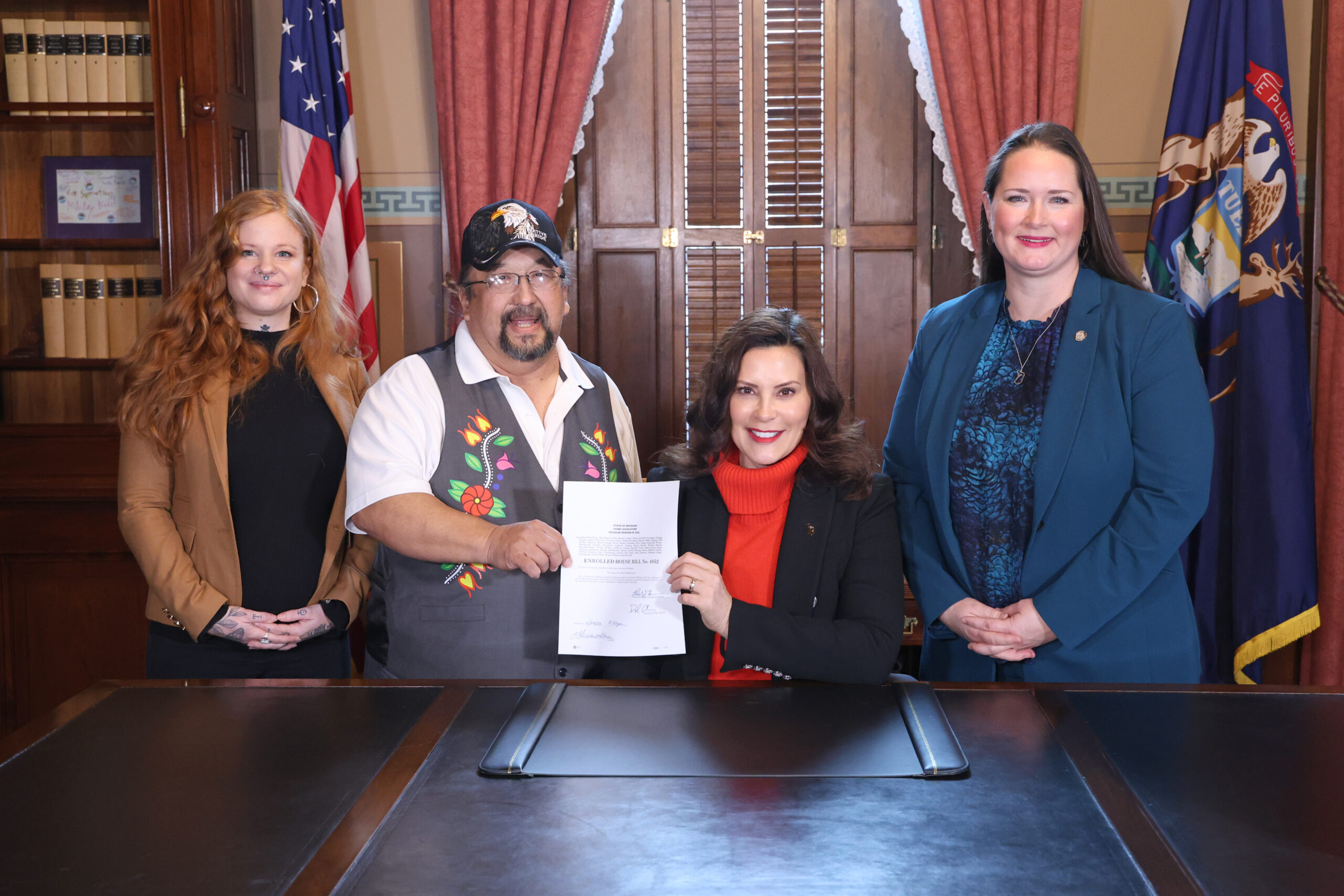 From left, Emily Paski, Gov. Whitmer’s tribal liaison; Roger LaBine, elder and rice keeper in the Lac Vieux Desert Band of Lake Superior Chippewa; Gov. Gretchen Whitmer and state Rep. Carrie Rheingans (D-Ann Arbor) pictured after the signing of House Bill 4852 at the Capitol in Lansing on Dec. 5, 2023.