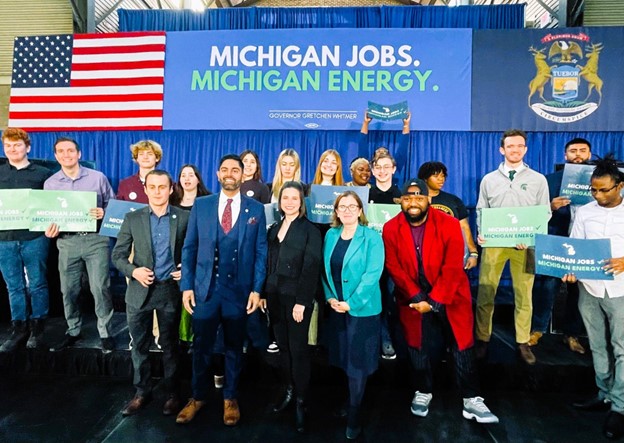Rep. Price stands with fellow Michigan Legislature members and stakeholders at the clean energy bill signing in Detroit.