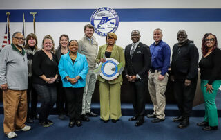 State Rep. Amos O’Neal (D-Saginaw), fourth from right, and Buena Vista Charter Township officials accept the Redevelopment Ready Certification plaque on Dec. 18, 2023, at the township offices.