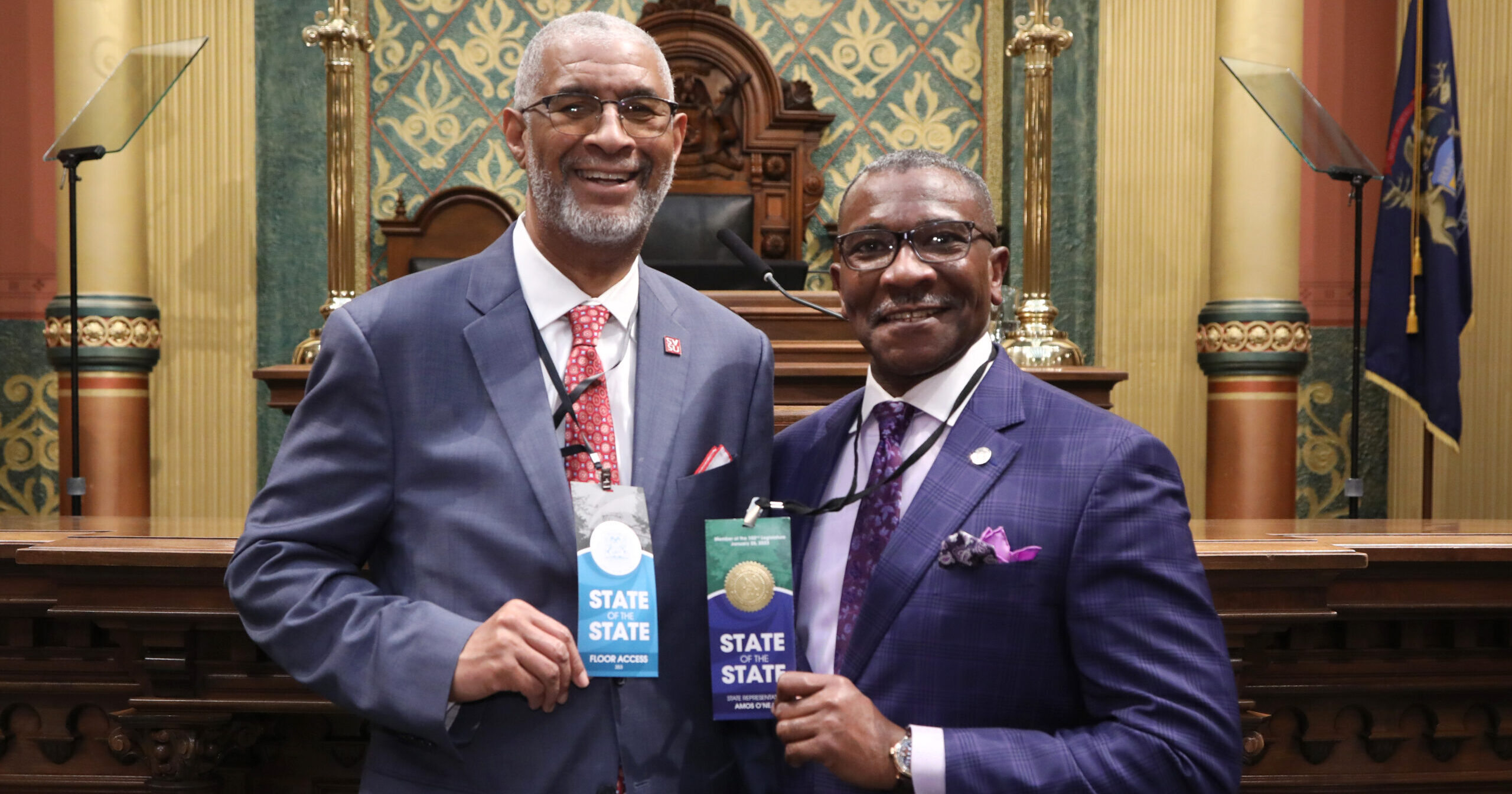 Michigan State Representative Amos O'Neal smiles at the 2023 State of the state with unknown guest.