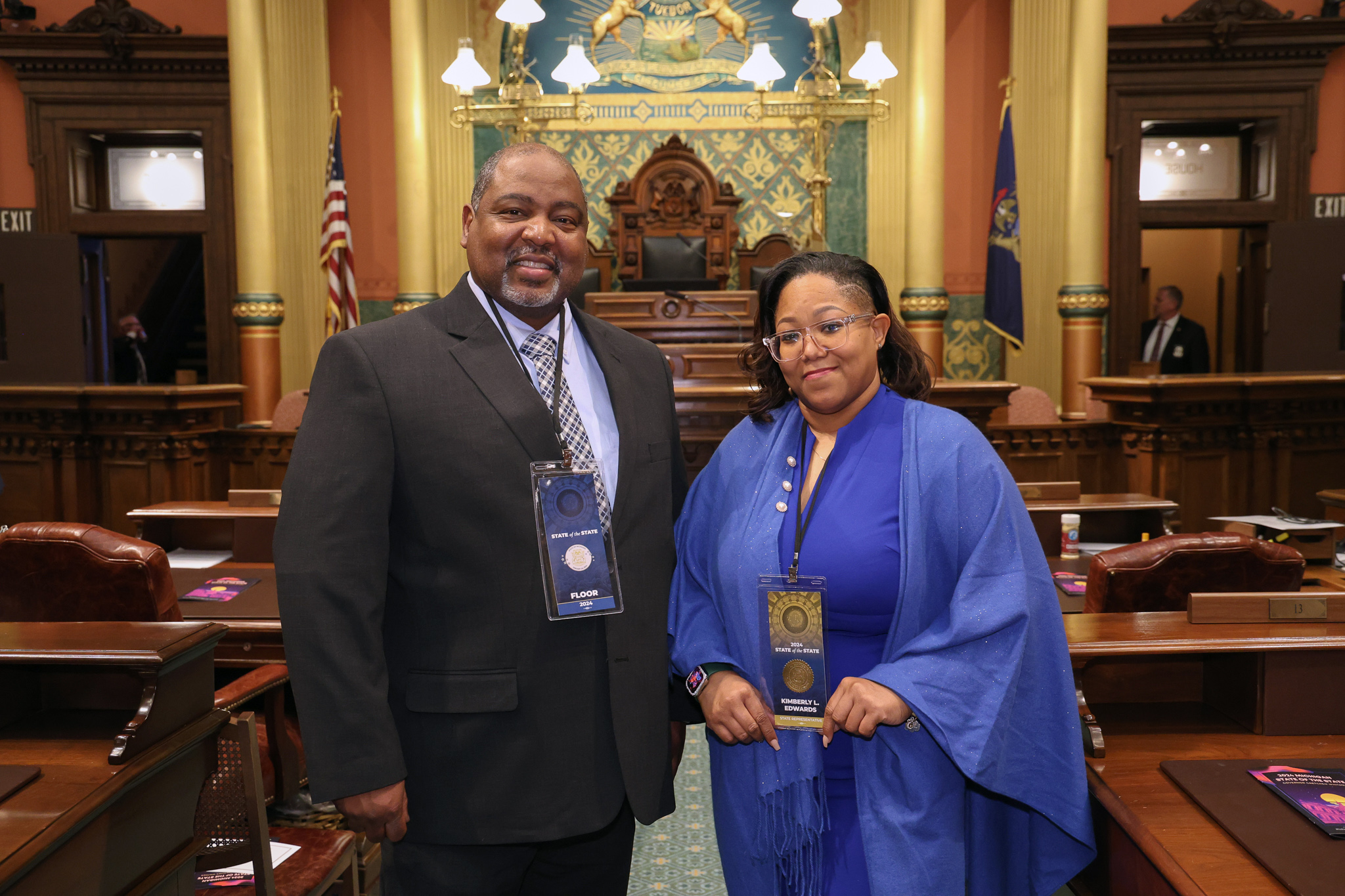 State Rep. Kimberly Edwards stands with Detroit Police Commander Lawrence Purifoy on the Michigan House floor.