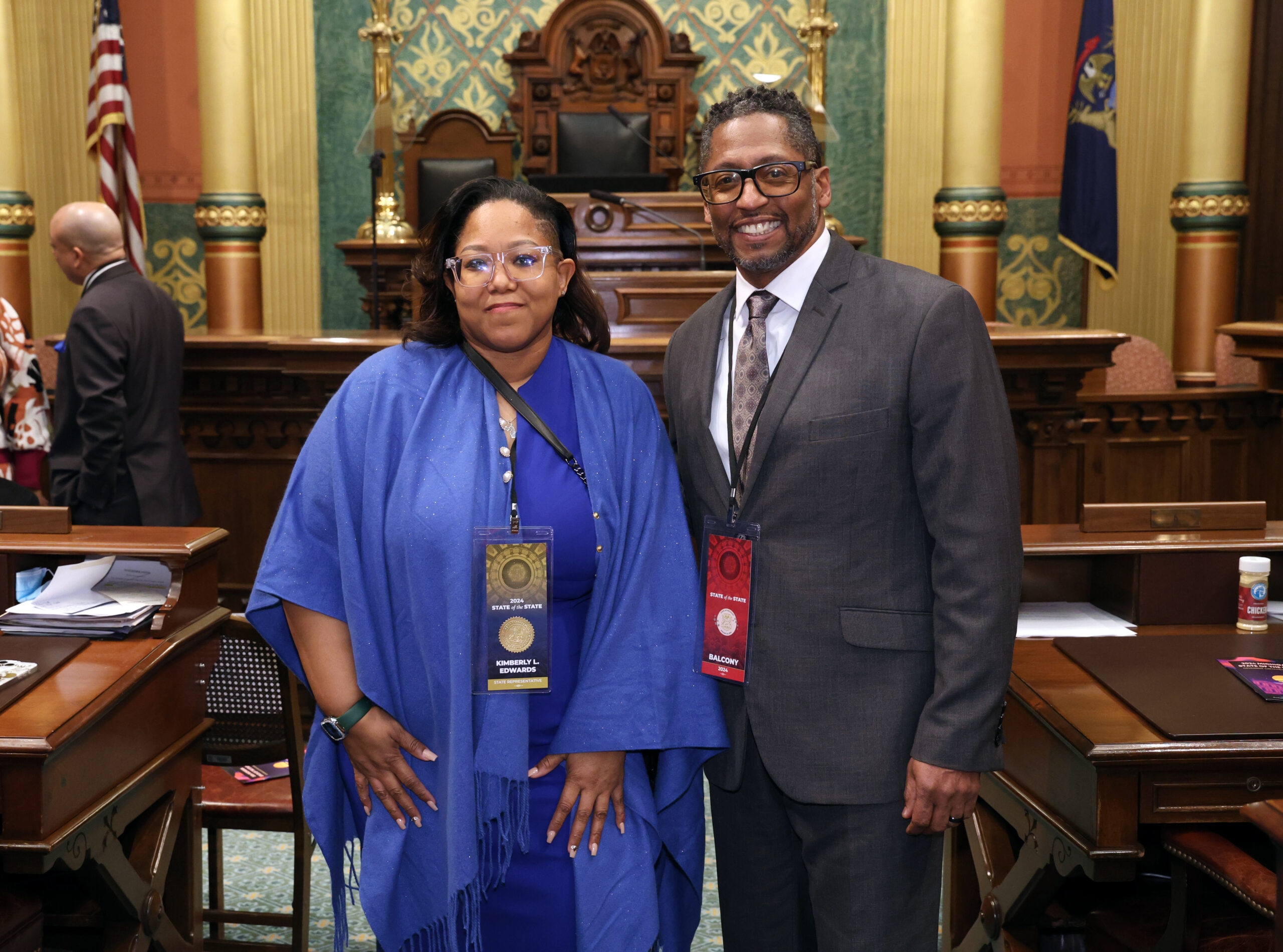 State Rep. Kimberly Edwards stands with Pastor Kevin Lawrence on the Michigan House floor.