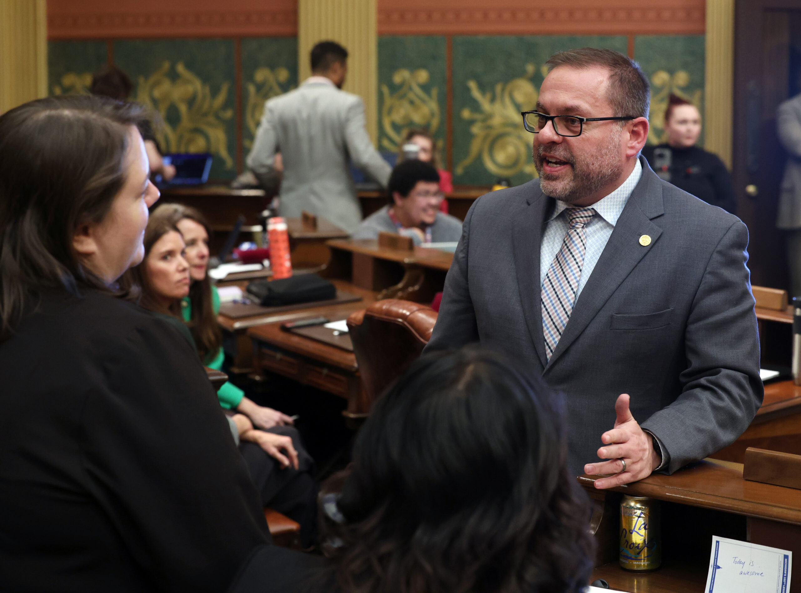 Rep. McFall speaks with colleagues on the Michigan House of Representatives floor.