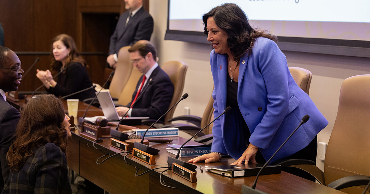 House Appropriations Chair state Rep. Angela Witwer (Delta Township) greets Gov. Gretchen Whitmer and Lt. Gov. Garlin Gilchrist at a joint meeting of the House and Senate Appropriations committees on Feb. 7 at the Michigan Capitol.
