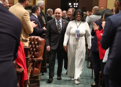 Rep. Brenda Carter walking down the aisle of the House Chambers.