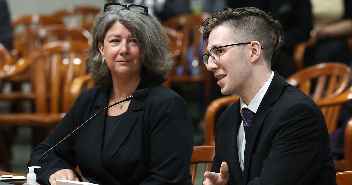 Alex Bowerson (right), cardiac survivor and heart safe schools advocate, speaks in support of the bills on March 5, 2024 during a House Committee on Regulatory Reform hearing in Lansing.