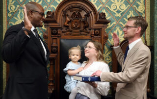 State Rep. Peter Herzberg (D-Westland) stands with family as he is sworn into the Michigan House of Representatives on April 30, 2024, on the House Floor of the Capitol in Lansing.