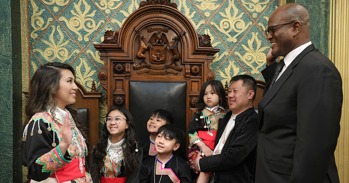 State Rep. Mai Xiong (D-Warren) stands with family as she is sworn into the Michigan House of Representatives on April 30, 2024, on the House Floor of the Capitol in Lansing.