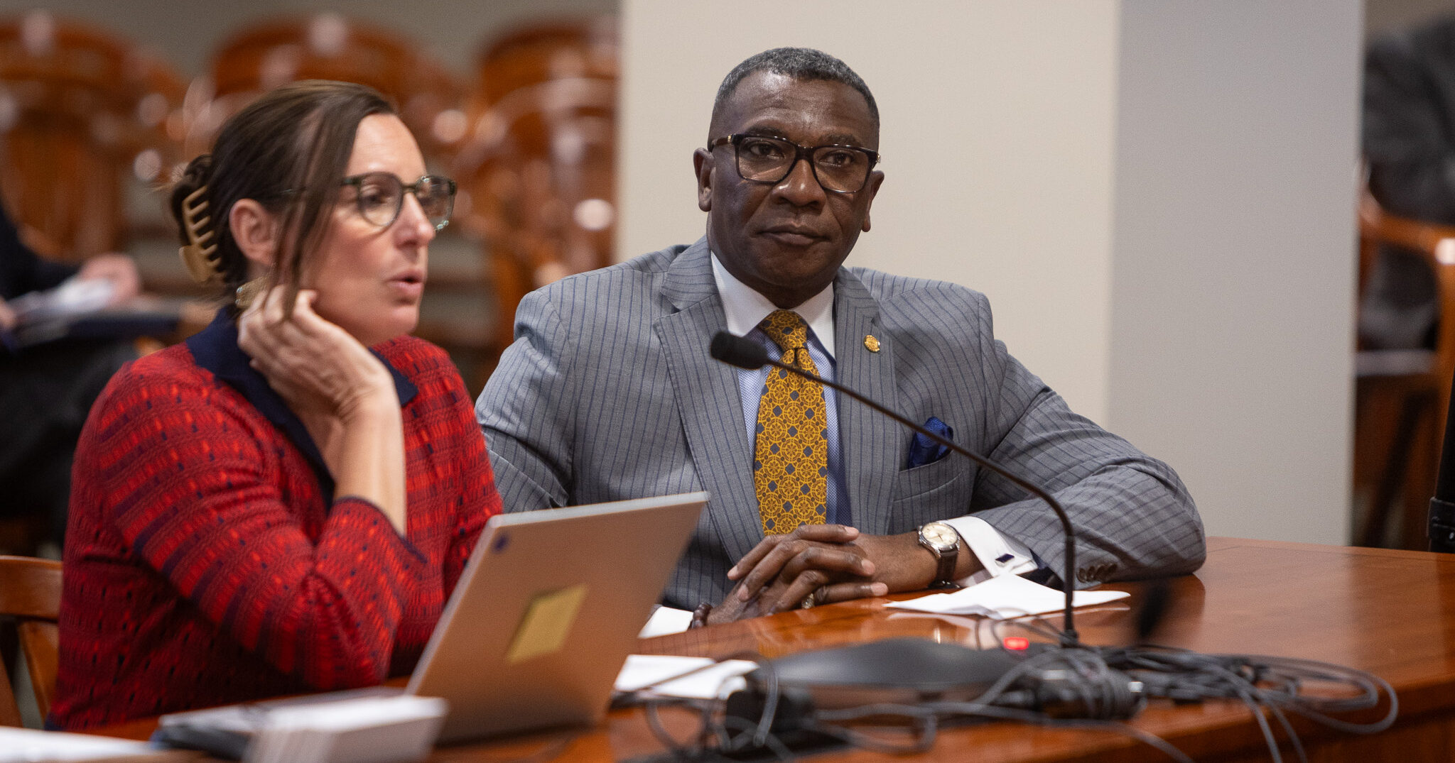 Michigan state representitve Amos O'Neal sits with his hands folded during a committee hearing.