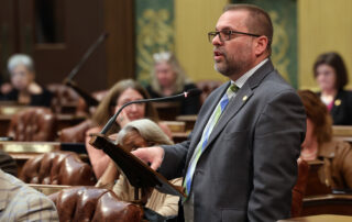 State Rep. Mike McFall (D-Hazel Park) speaks at a podium on the House Floor on Tuesday, May 7, 2024, at the state Capitol in Lansing.