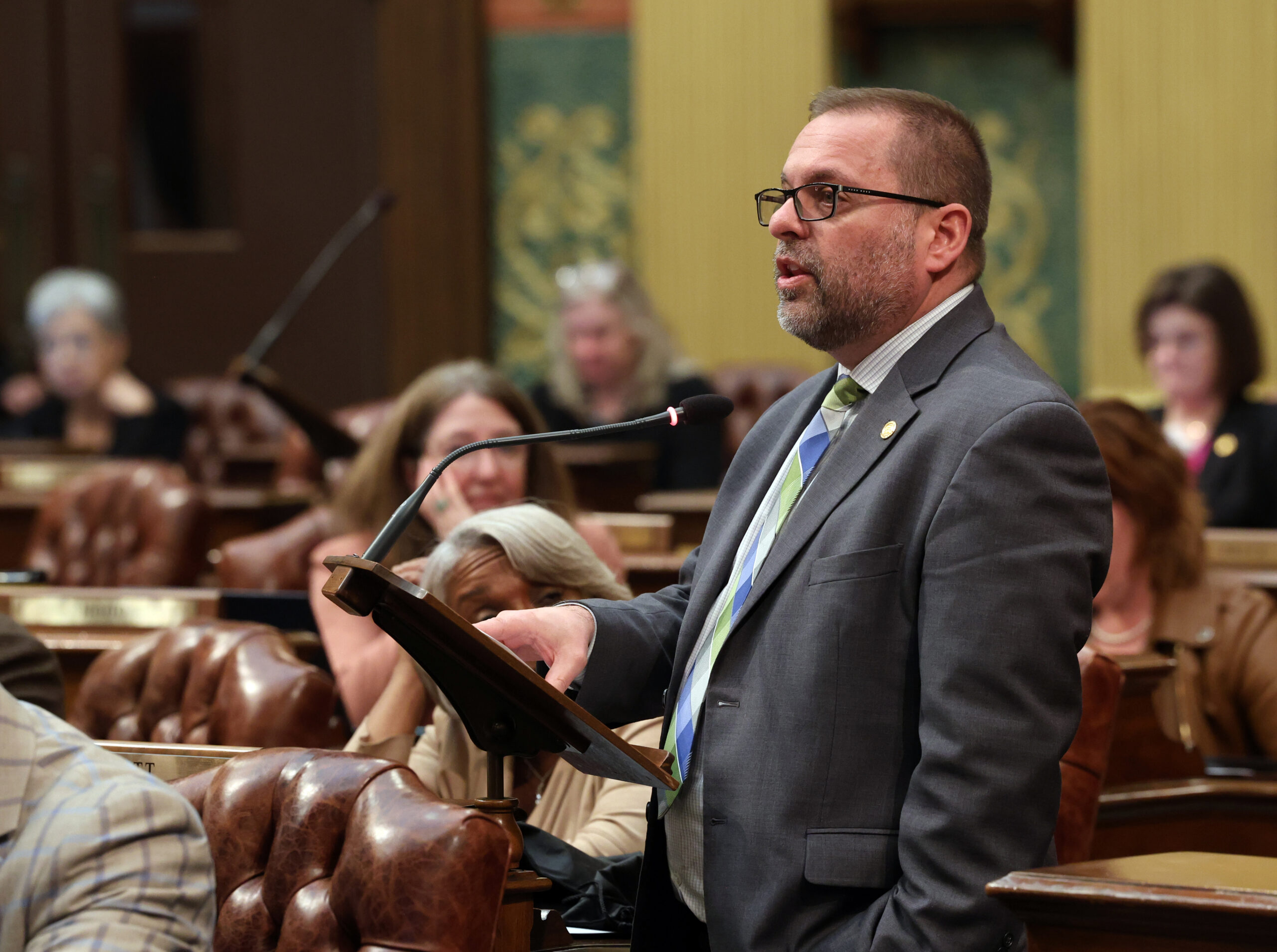 State Rep. Mike McFall (D-Hazel Park) speaks at a podium on the House Floor on Tuesday, May 7, 2024, at the state Capitol in Lansing.