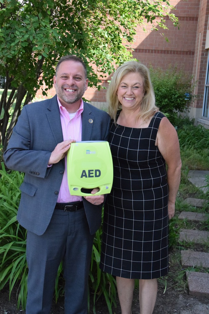 Rep. McFall presents an AED to Hazel Park Schools.