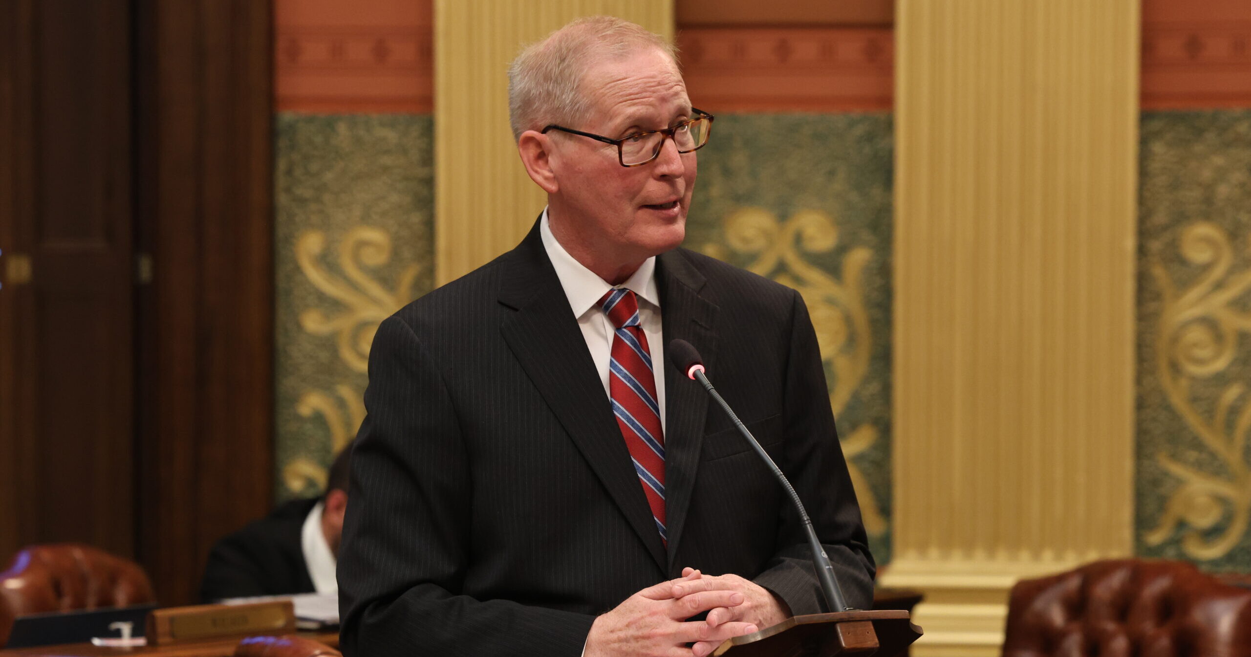 Michigan state Representative Jim Haadsma speaks in support of a budget amendment on the floor of the Michigan House of Representatives.