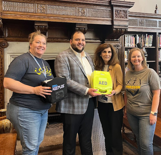 Alabas Farhat, delivering an automated external defibrillator (AED) to Fordson High School..