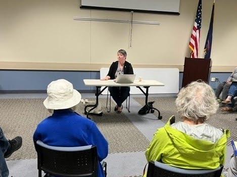 State Rep. Betsy Coffia speaking to constituents at her monthly office hou.