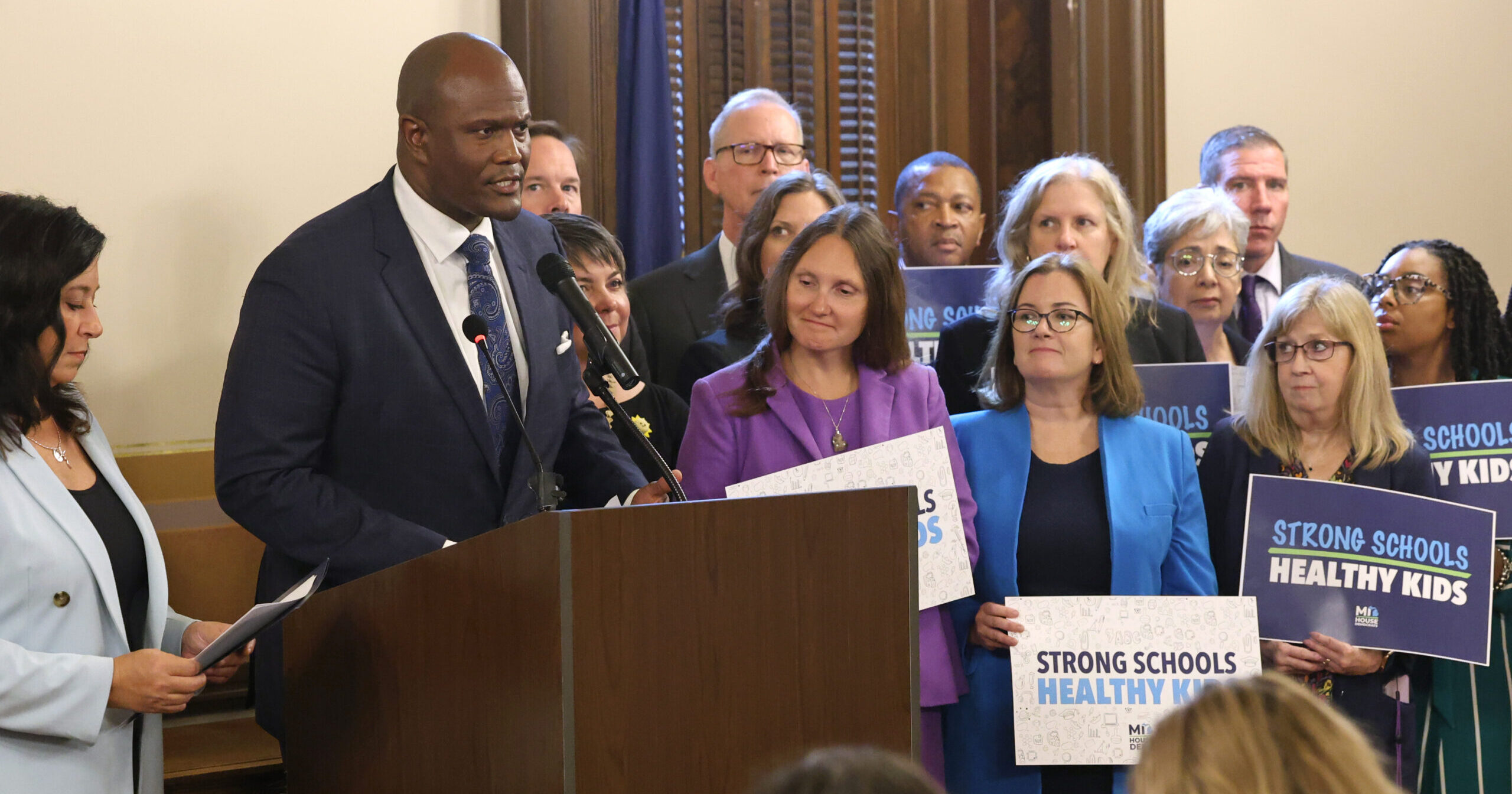 Speaker of the House of Representatives Joe Tate stands at talks during a press conference surrounded by his colleagues.