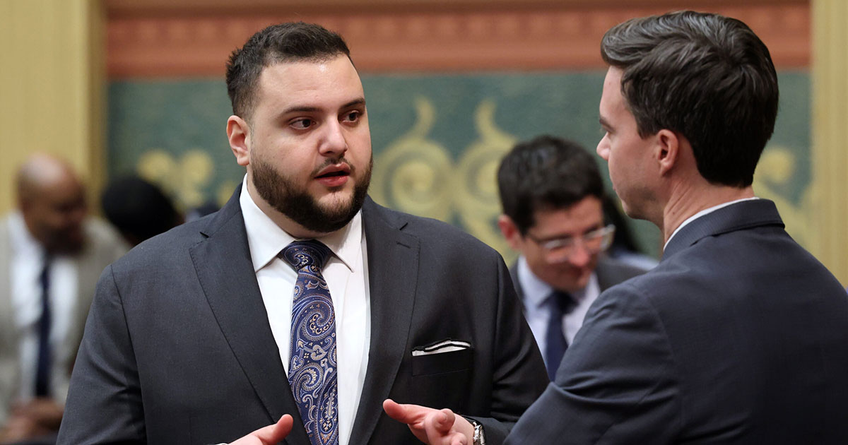 State Rep. Alabas Farhat (D-Dearborn) has a conversation on the House Floor in Lansing.