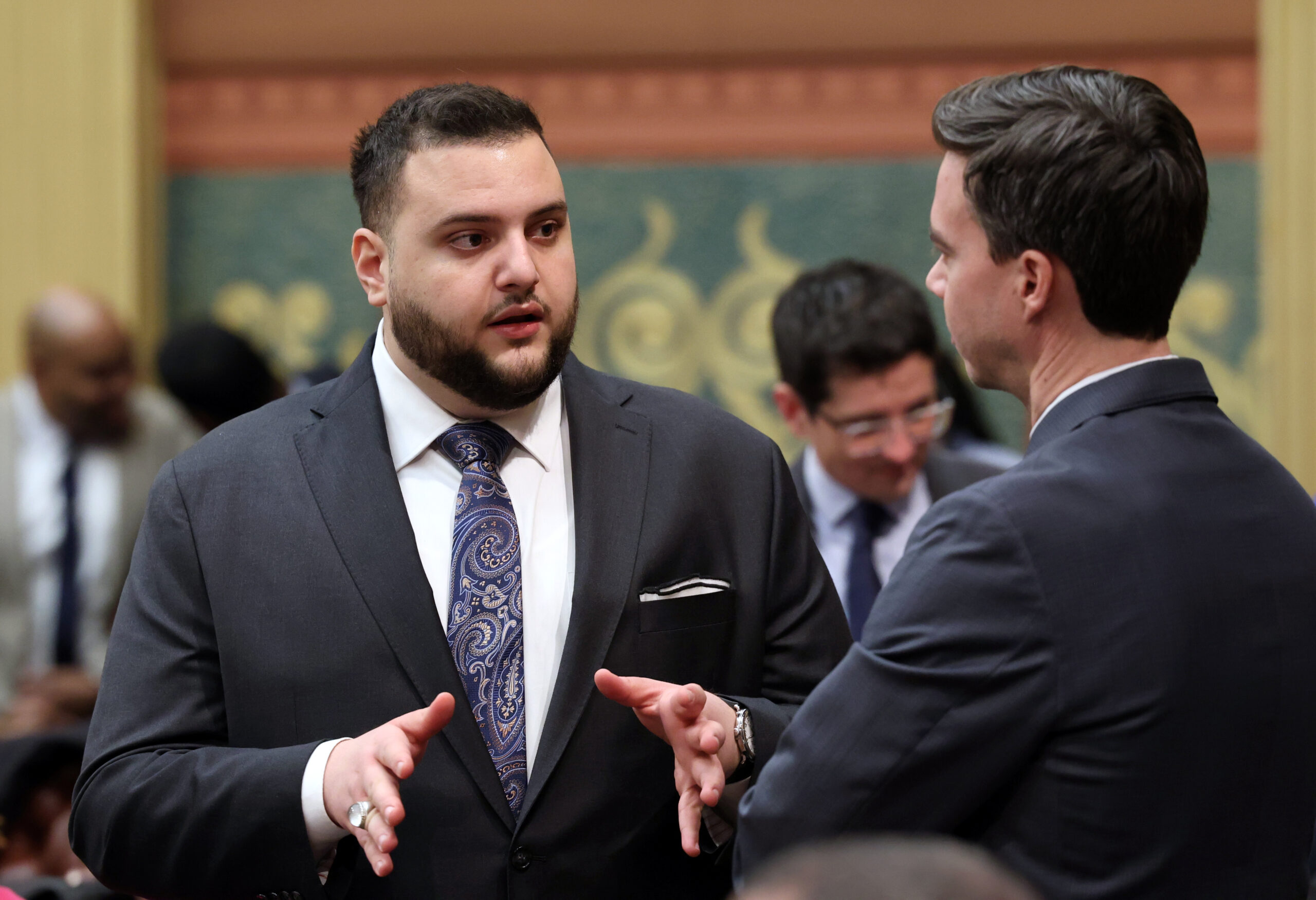 Michigan State Representative Alabas Farhat has a conversation on the House floor.