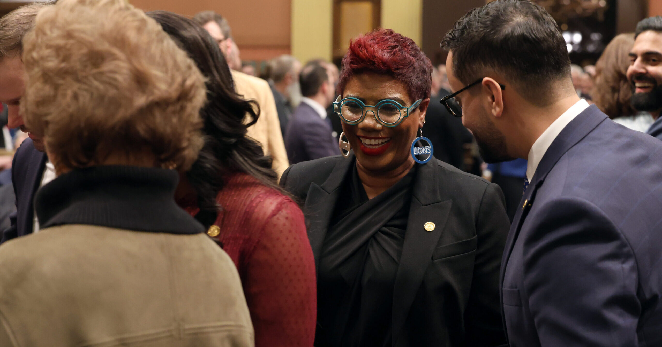 Michigan State Representative Cynthia Neeley smiles cheerfully on the house floor