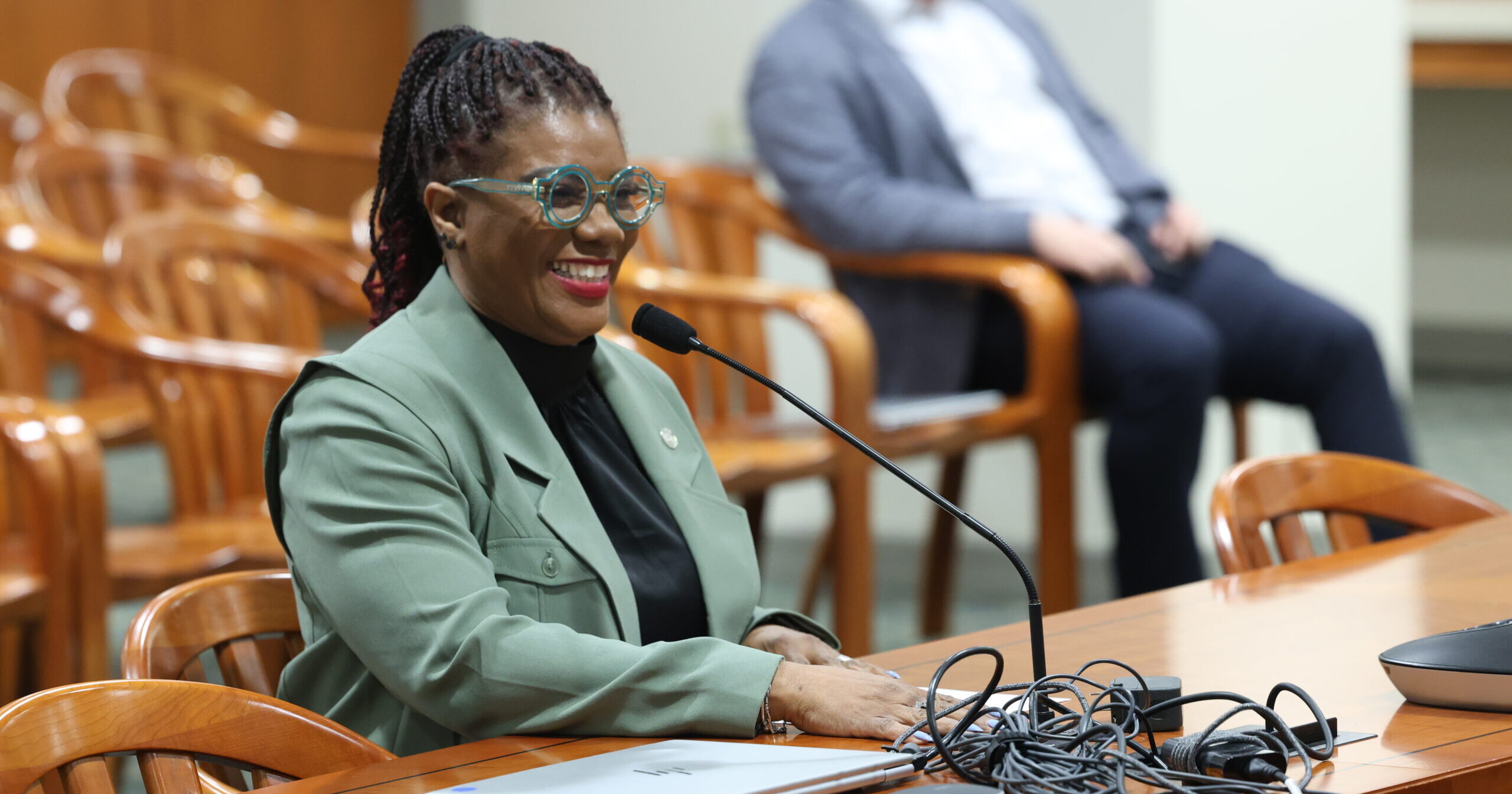 state Representitive Cynthia Neeley smiles as she sits to give testimony in committee.