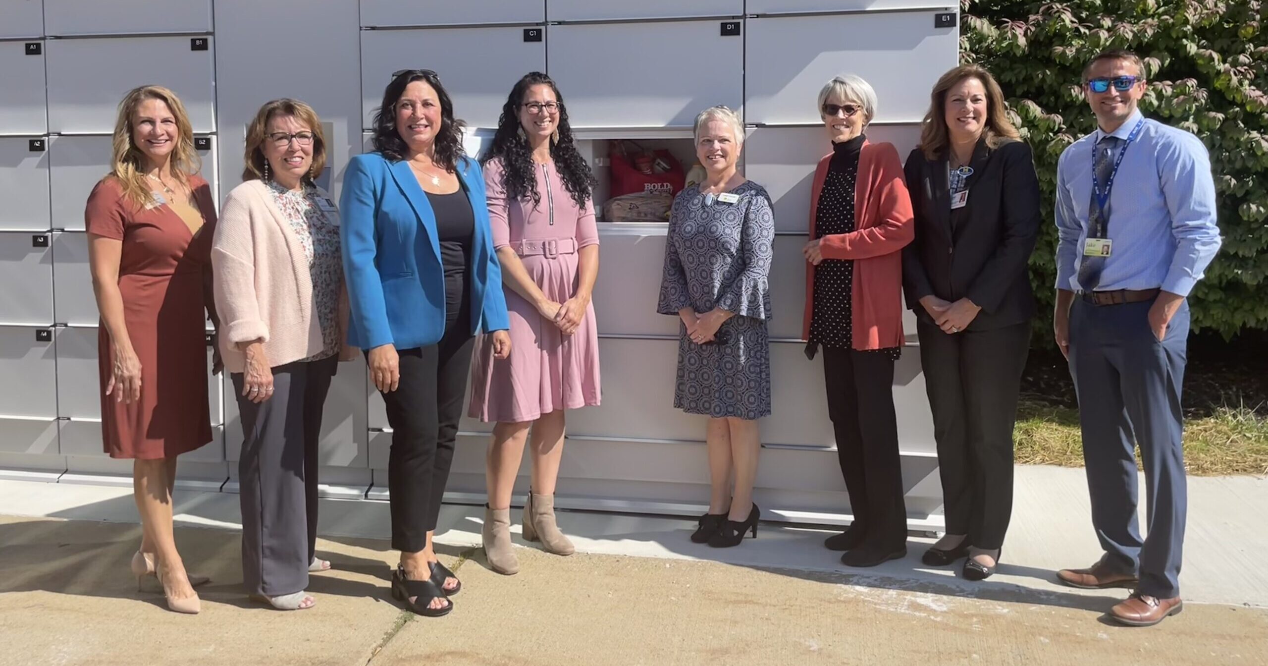 State Representative Angela Witwer stands with community officials in front of Michigan's first smart food lockers in Eaton County.