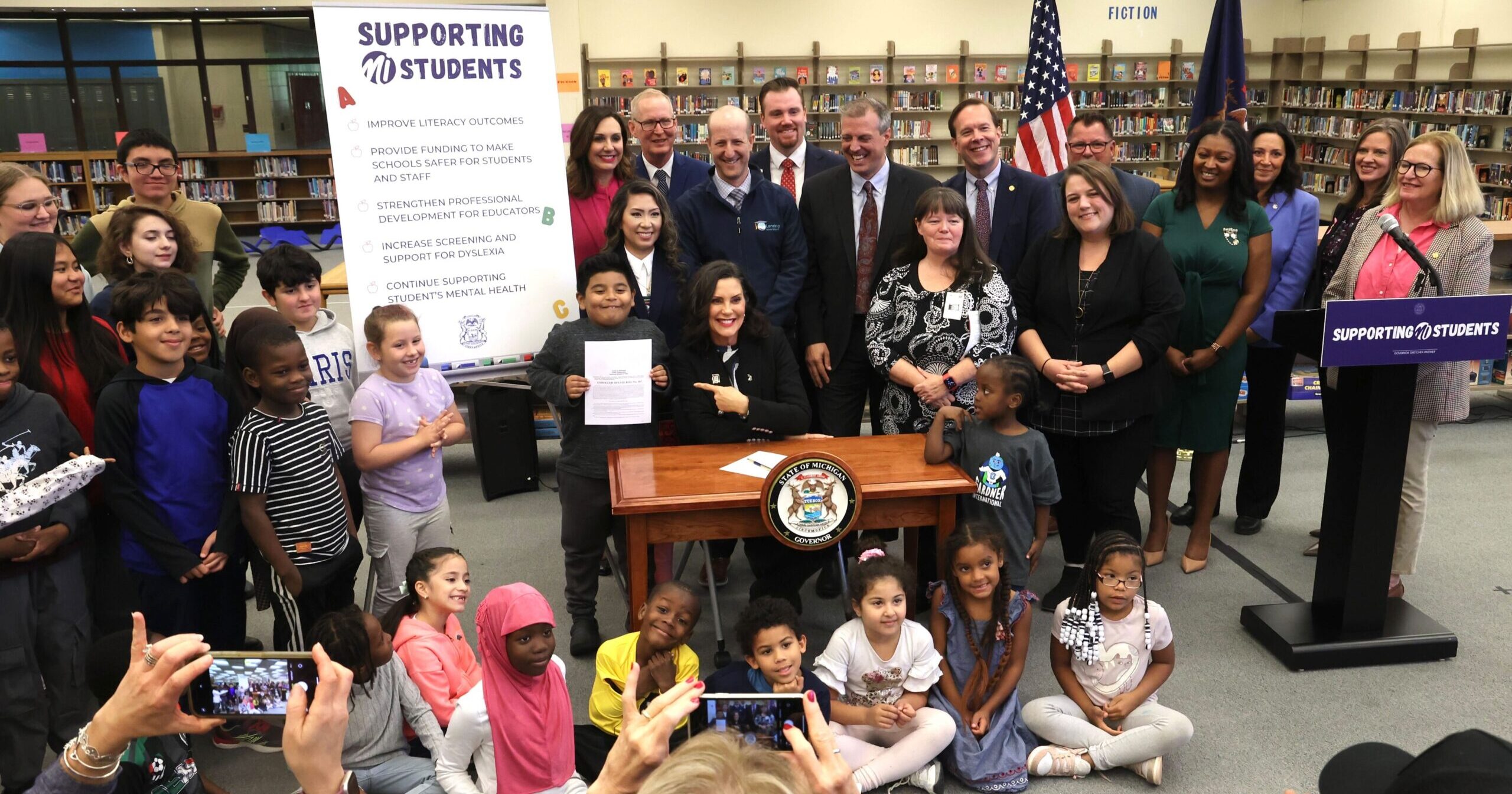 Lawmakers including State Rep. Regina Weiss (D-Oak Park), pictured with Gov. Whitmer for education bill signing, Oct. 10, 2024.