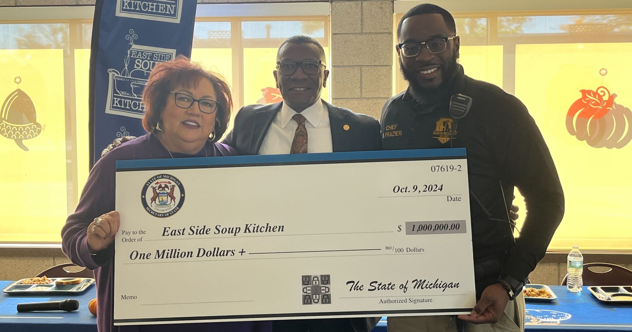 From left, Diane Keenan, executive director of East Side Soup Kitchen, state Rep. Amos O’Neal (D-Saginaw), and Kentrez Frazier, chief executive officer of Dakota Security, hold a check representing the secured $1 million dollar investments for East Side Soup Kitchen