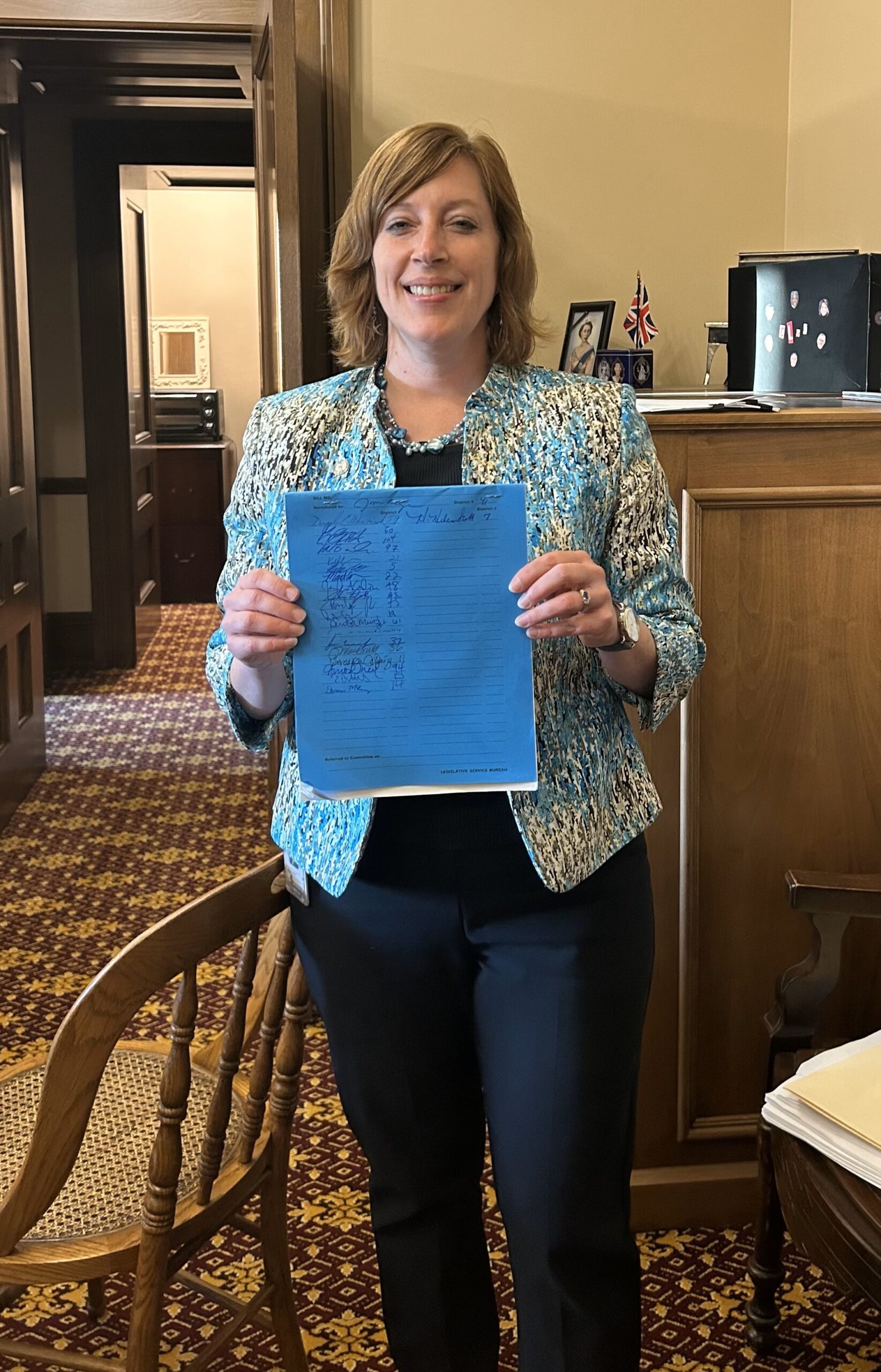 Michigan State Representative Julie Rogers holds up her House Bill.