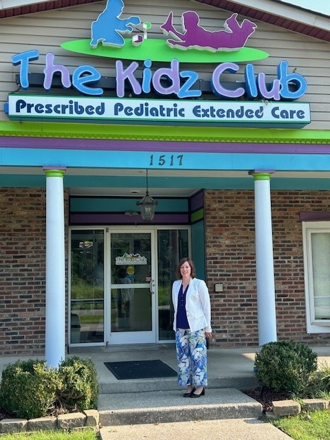 Michigan State Representative Julie Rogers stands in front of a prescribed pediatric extended care facility.