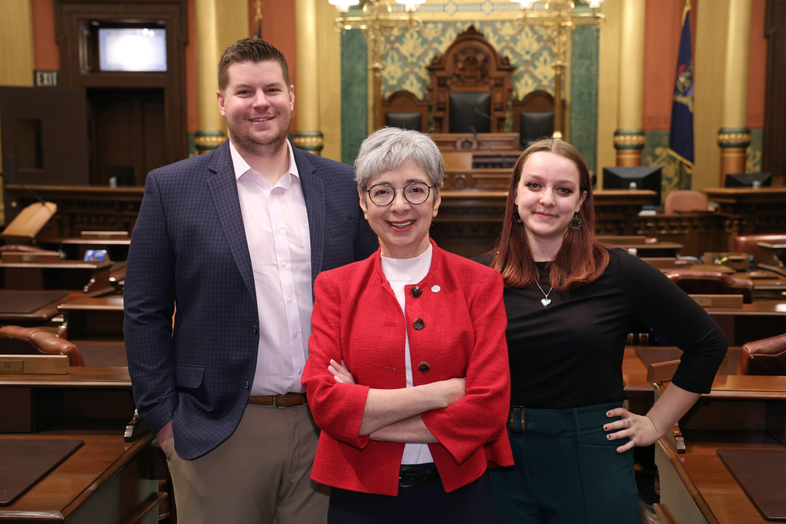 Michigan State Representative Veronica Paiz stands with her office staff, James Sklar and Abby Locke.