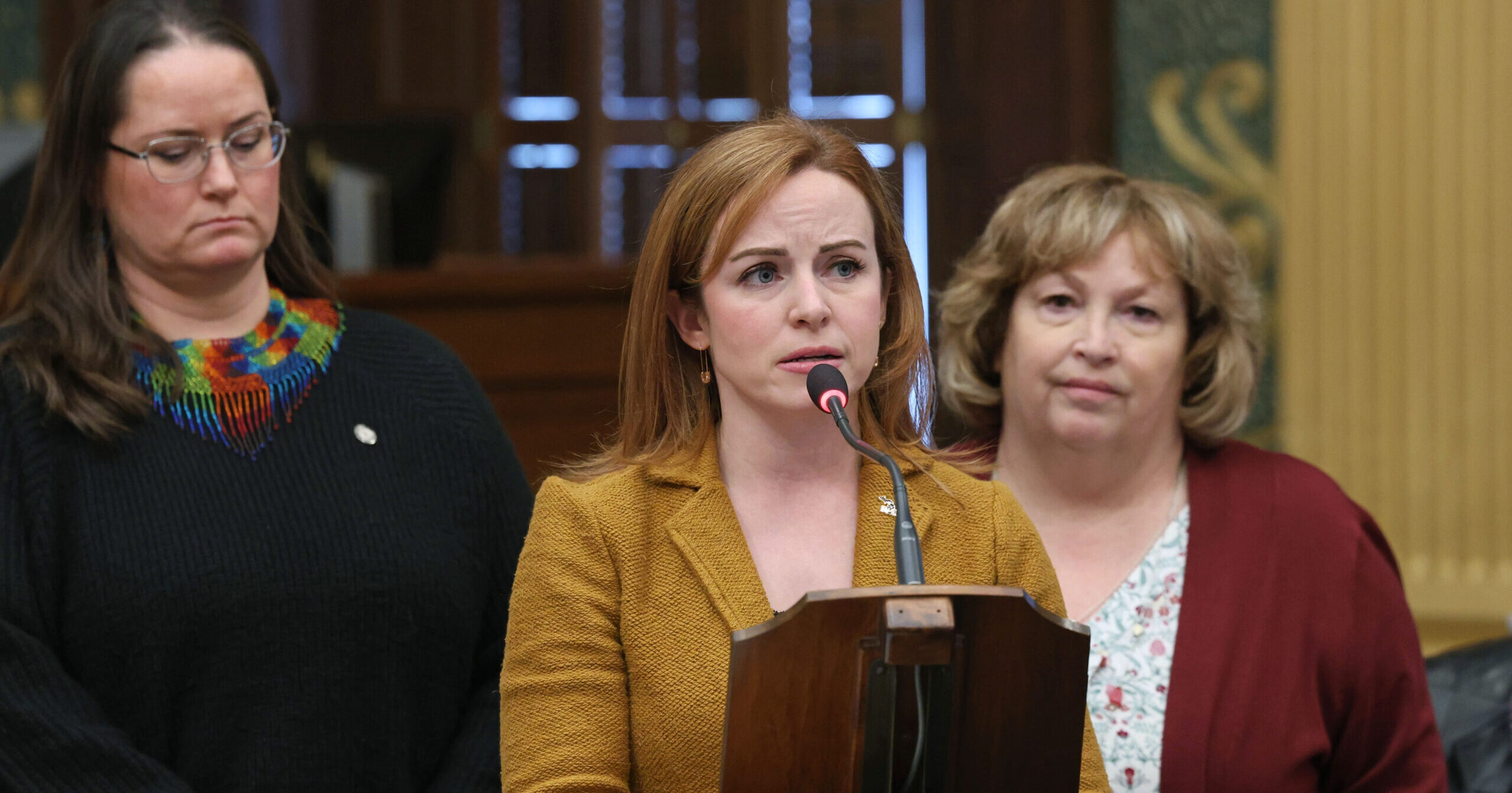 Michigan State Representative Erin Byrnes speaking behind a podium on the House Floor.