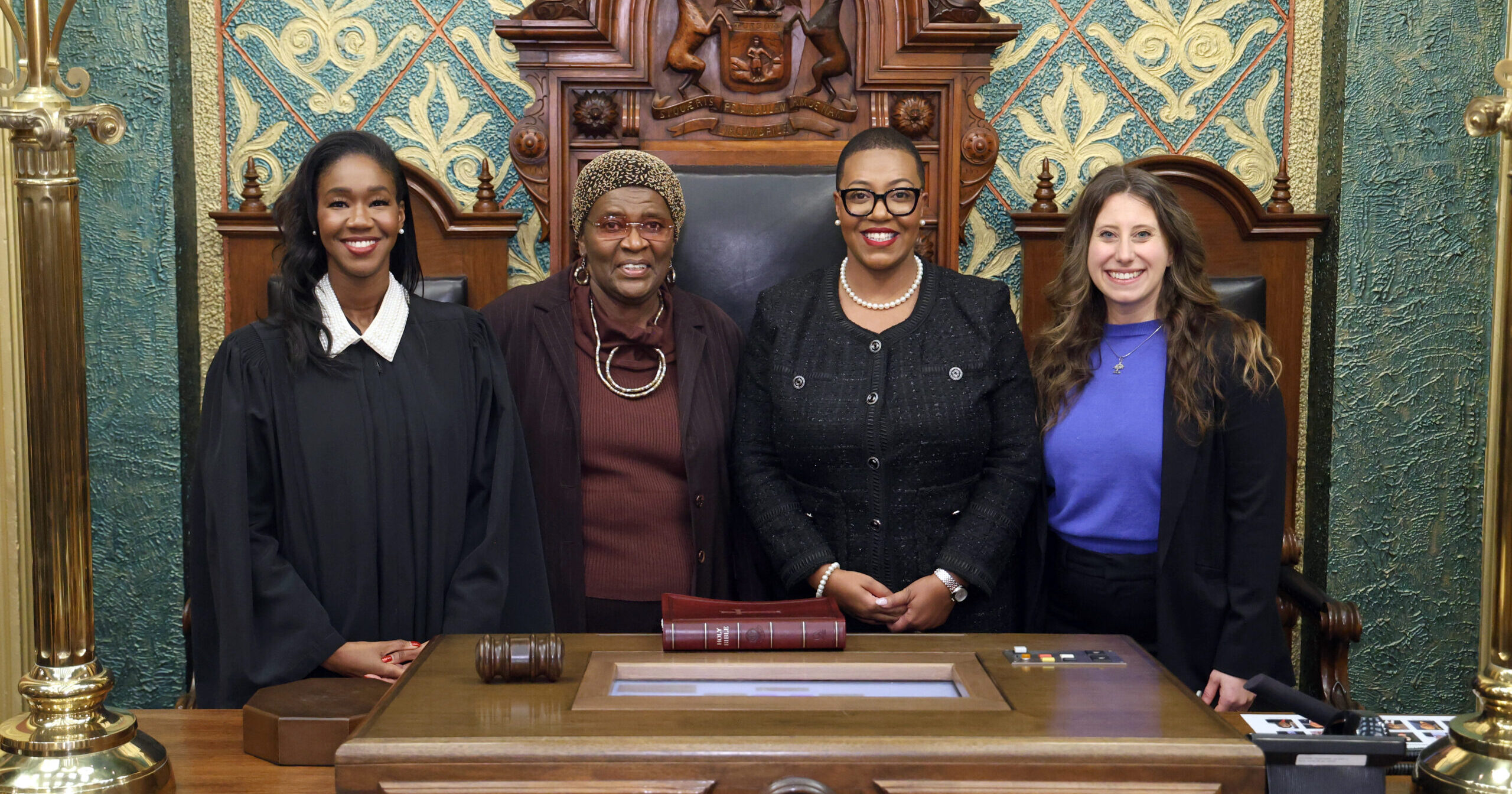 Image of Michigan State Representative Morgan Foreman smiling alongside Justice Kara Bolden and family and friends.