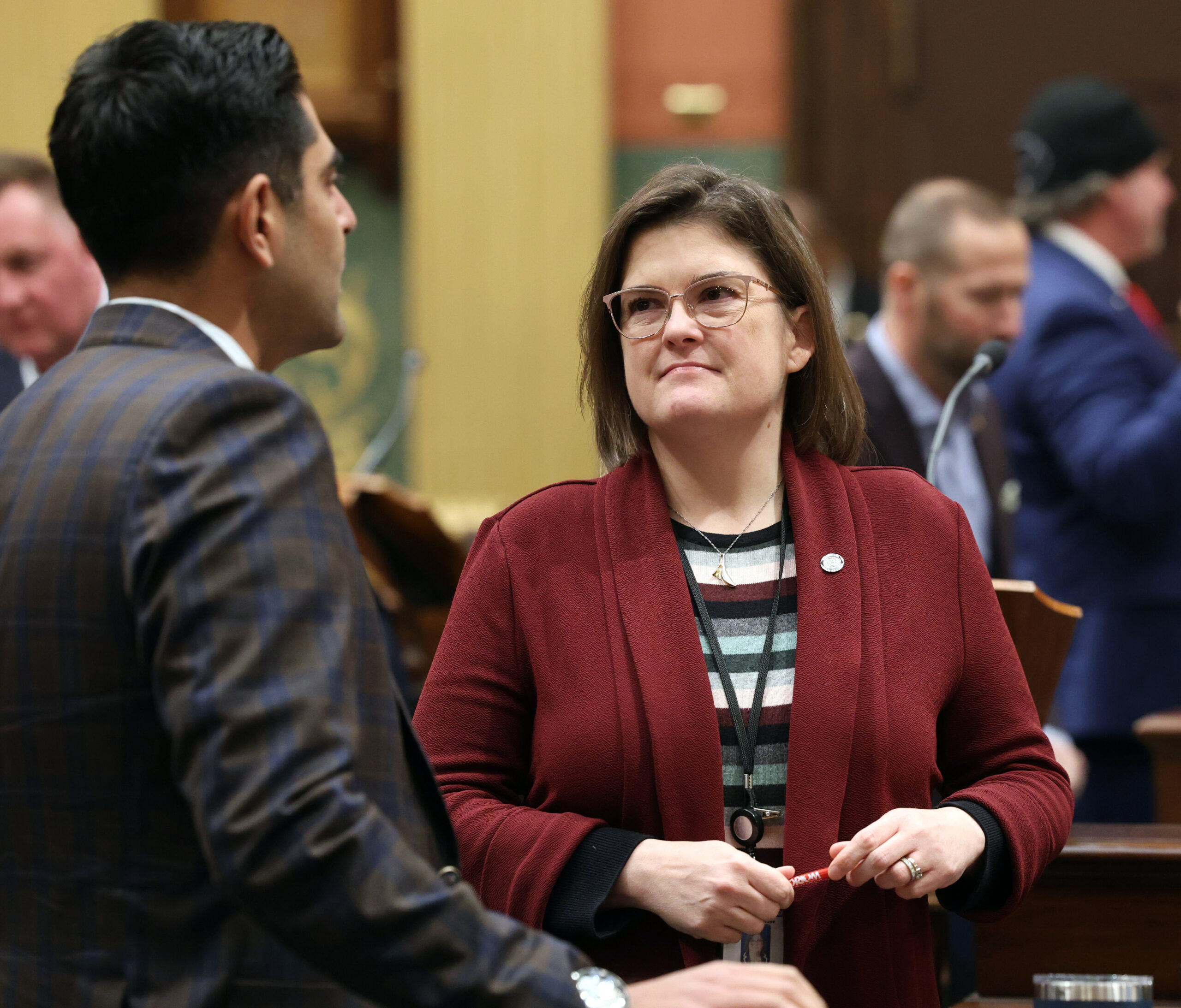 Michigan State Representative Kara Hope speaks with Democratic Leader Ranjeev Puri on the House floor.