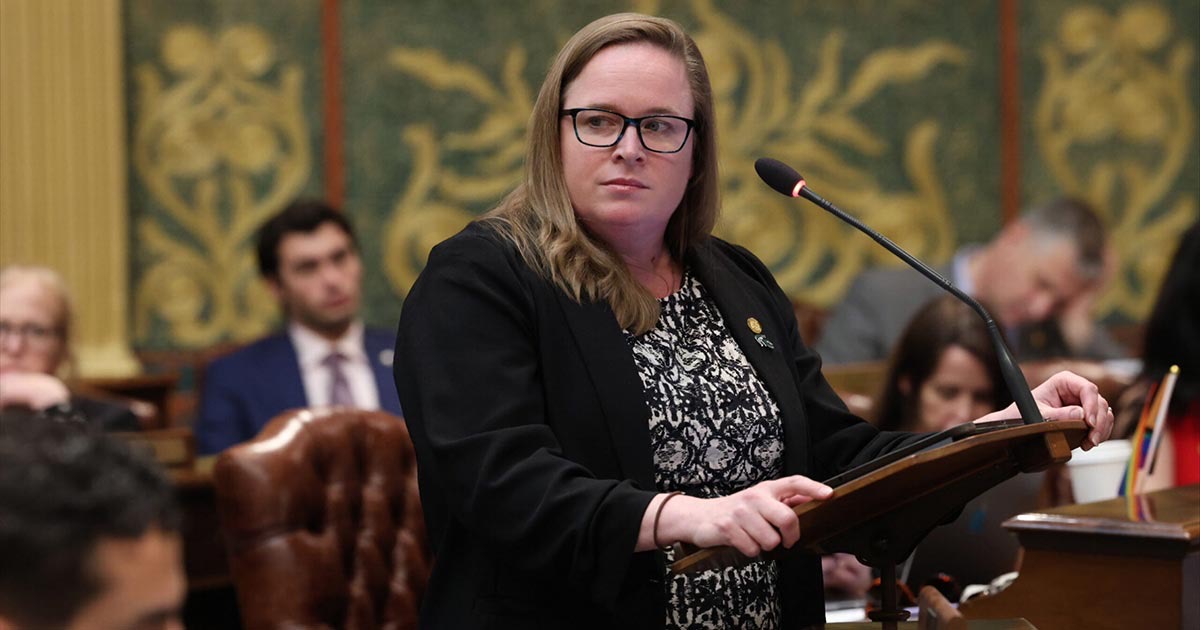 Michigan State Representative Kelly Breen speaking behind a podium on the House Floor.