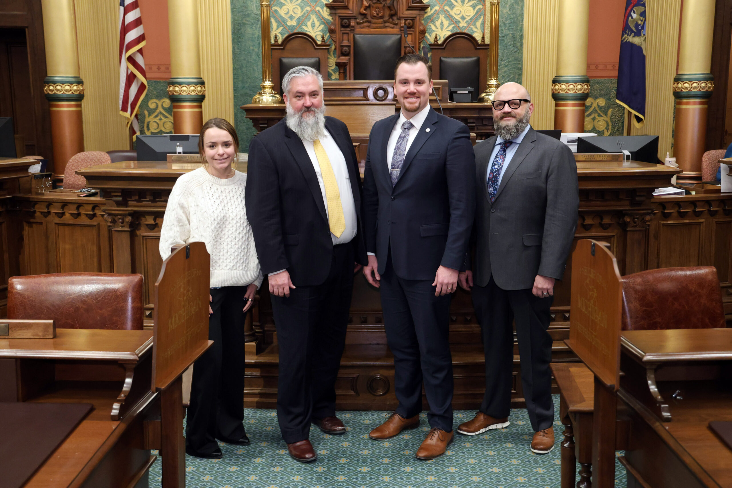 Michigan State Representative John Fitzgerald standing with his office staff on the House Floor.