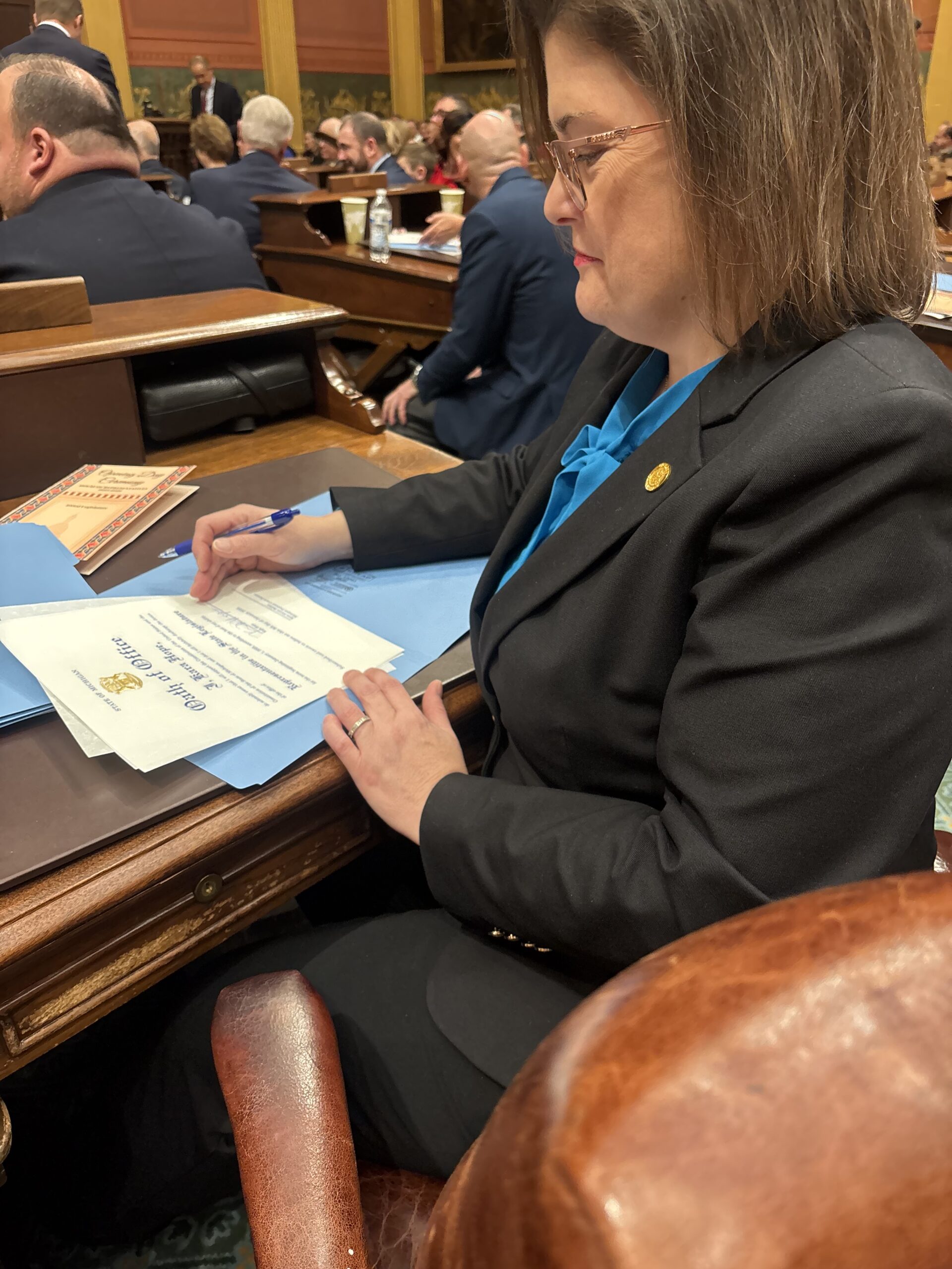 Michigan State Representative Kara Hope sits at her desk on the first day of Michigan's 103rd Legislature.